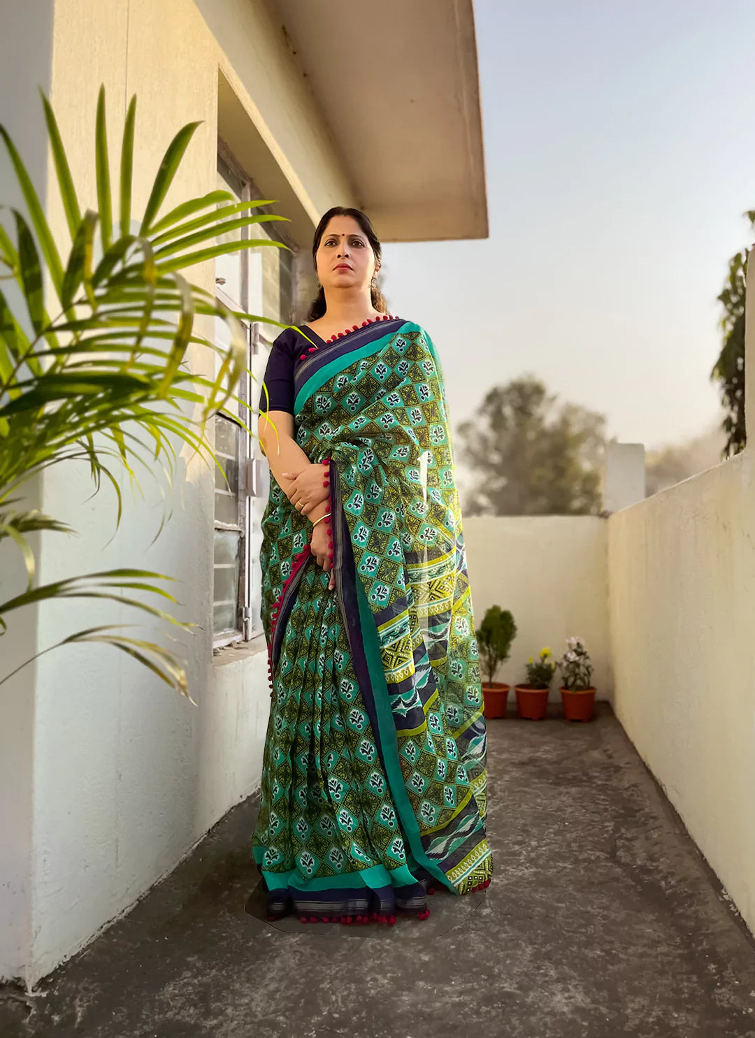 Printed Green Cotton Blend Saree With Pompoms treevesto
